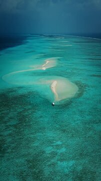 Aerial view of Maldives sandbank in turquoise lagoon