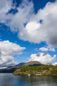 Scenic landscape of Lake Ashi with mountains and majestic clouds in Hakone, Japan