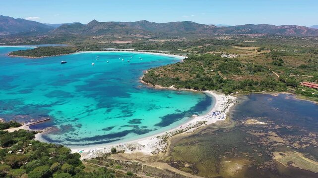 Spiaggia di Salina Bam 4K Aerial View of Cala Brandinchi SARDINIA  , Lu Impostu Bays. Cinematic aerial Drone Flight over Little Tahiti Turquoise Sea and White Sand.  Best beaches of Sardinia