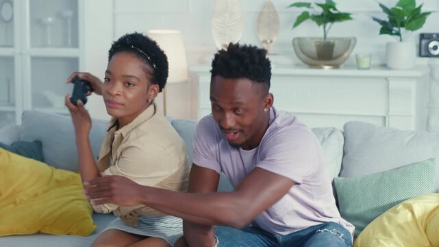 A Couple Engaging in a Fun and Enjoyable Gaming Session Together in Their Cozy Home Space