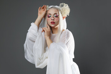 Naklejka premium Beautiful girl dressed as elf on grey background