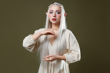 Naklejka premium Beautiful elf girl on dark olive background