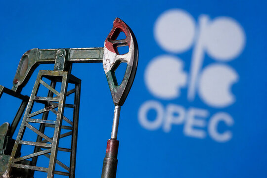 Oil pump jack against blue background with opec logo.