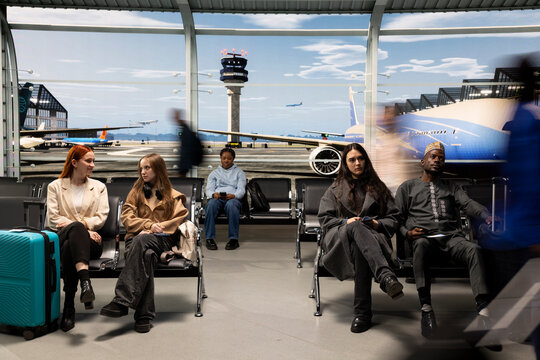 Diverse crowd waiting in busy airport lounge, dynamic movement blur concept. Passenger enduring long flight layover before next airplane departure in transit hub, long exposure shot