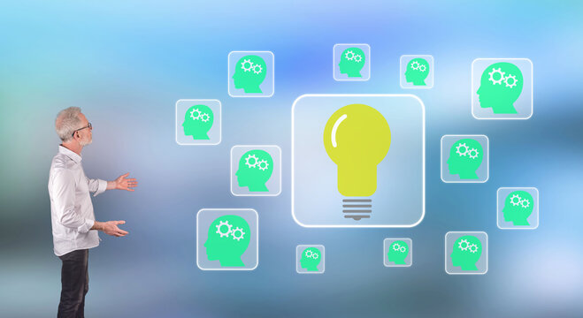A teamwork idea concept explained by a businessman on a wall screen