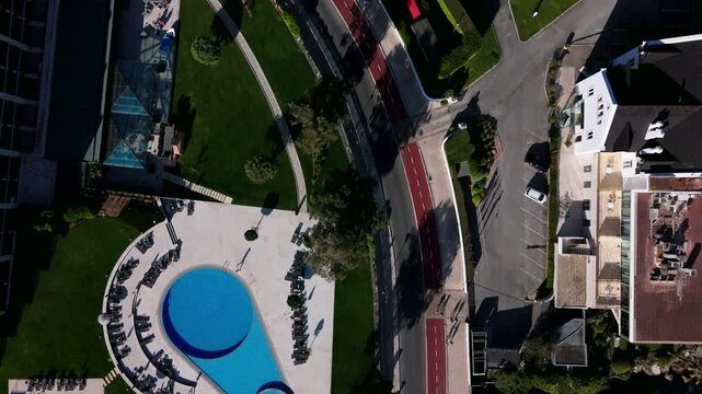 Aerial view of teardrop-shaped outdoor pool and sun loungers. Cascais, Portugal