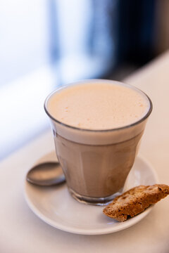 close up shot of coffee with cracker on the side