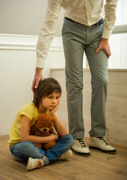 Father comforting sad child.