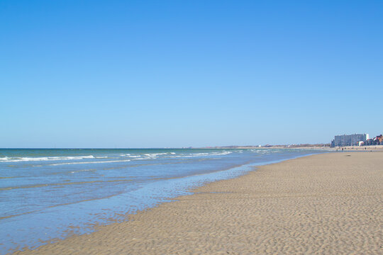 Dunkirk beach, Plage Dunkerque, promenade near the sea, coastline, sand, dunes, Malo-les-Bains, France, La Manche, people walking far away, a large beach known from the Second World War