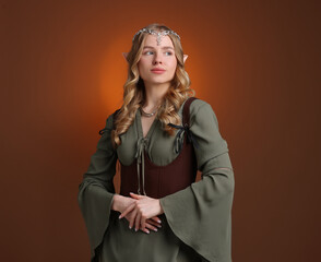 Naklejka premium Beautiful elf girl on brown gradient background, space for text