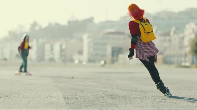 Young woman with pink hair inline skating outdoors