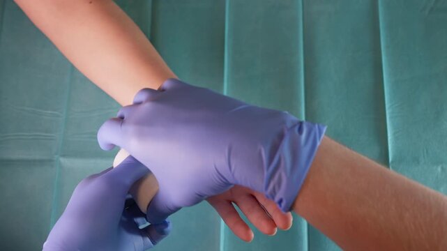 Medical Professional Bandaging a Patient's Wrist - First Aid and Healthcare Concept