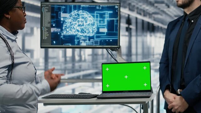 Green screen laptop, monitoring PCB smart factory workflow and businesspeople using AI neural network. Tracking microchip production, mockup notebook and executives using machine learning, camera B