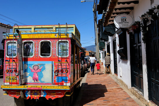 Villa de Leyva, Colombia - 04 February 2026. Colorful traditional rural bus from Colombia called chiva parked at the beautiful colonial town of Villa de Leyva in Colombia.