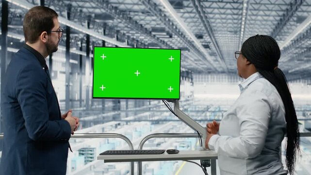 Green screen monitor, monitoring semiconductors and businesspeople in industry 4.0 factory with automated production lines. Reviewing analytics, mockup display and microchips plant team, camera B