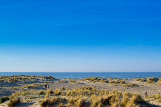 Dunkirk beach, Plage Dunkerque, promenade near the sea, coastline, sand, dunes, Malo-les-Bains, France, La Manche, people walking far away, a large beach known from the Second World War