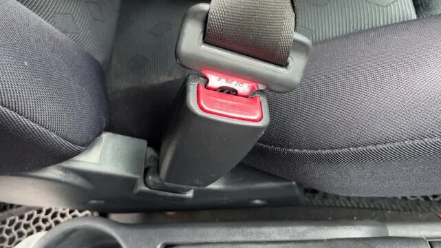 4K Close up of fastening a car seat belt with a loud clicking sound effect
