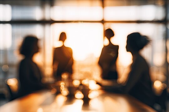 A blurred, warm-toned image depicts silhouetted figures gathered around a table, creating an abstract and intimate atmosphere.