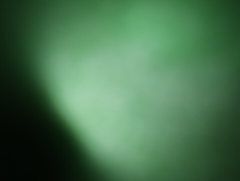 Una toma de cerca de un fondo abstracto de   color verde con negro con un degradado ligero desenfocado
