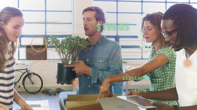 Team of four passing tablet and placing plant initiating cardboard box packing with office overlays