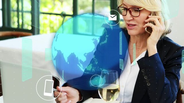 Business pro holding phone, tapping laptop while call starting globe overlaying chat icons for work