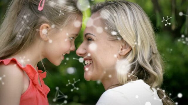 Child pressing foreheads, mother smiling back, bonding marketing, bokeh overlay drifting over faces