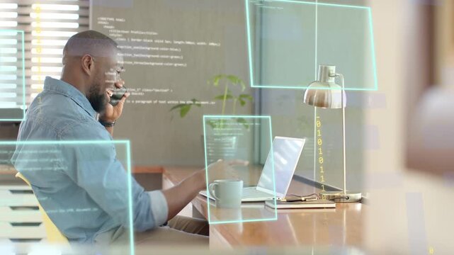 Man answering phone while tapping laptop in tech office, holographic code over screen, closing call