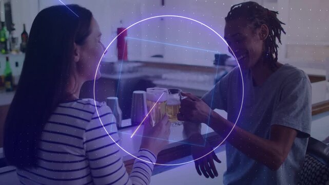 Woman standing man sitting at bar lifting beers sparking neon shapes on beers toasting pals social