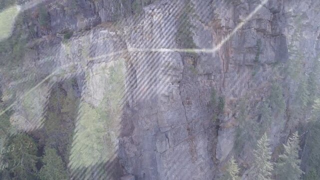 Platform moving, camera drifting while reflections sliding across cliff, revealing rock cracks