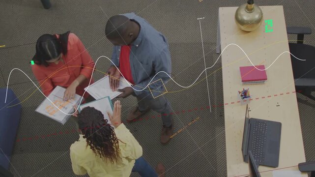 Team opening binders, comparing pages in business review, live overlays marking sections on pages