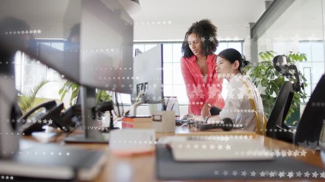 Mentor leaning, pointing and mentoring, trainee typing and aligning on business screen with stars