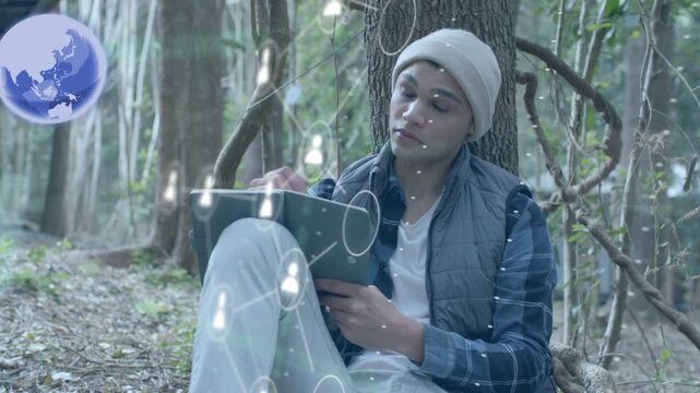 Man tapping tablet in forest generating expanding AR overlays with globe profiles for tech research
