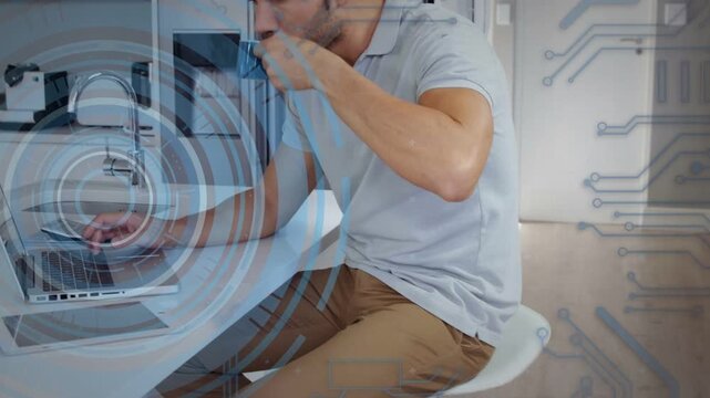 Man sipping mug, reaching laptop in kitchen, typing while animated code overlaying laptop for tech