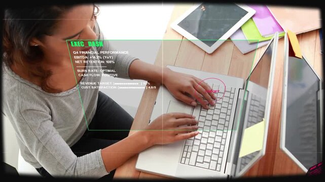 Adult woman typing on laptop while HUD appearing and TARGET marking keyboard for exec monitoring