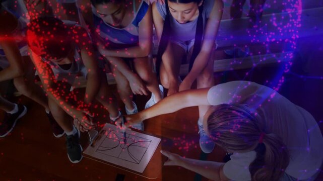 Coach drawing sports plays on clipboard, urging team following play, red purple particles sweeping