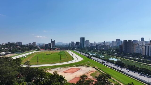 S&atilde;o Paulo skyline with Marginal Pinheiros and river, showing urban landscape, highways, bridges and modern buildings under clear blue sky.