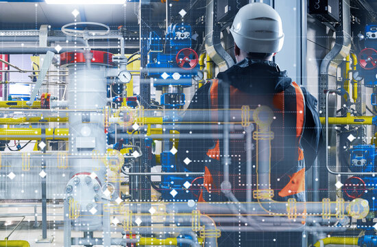 Engineer monitors automated gas pipeline network inside industrial plant control system.
