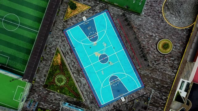 Aerial top view of a blue colored basketball court without people