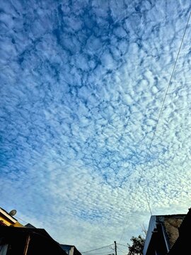 Beautiful Altocumulus Clouds Pattern Over Residential House Rooftops