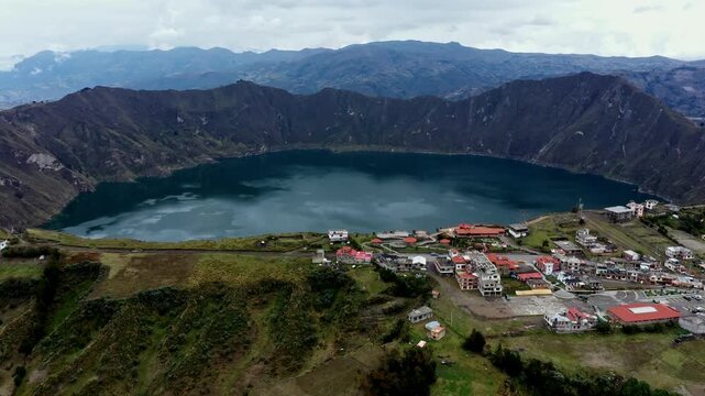 Quilotoa, Ecuador: 3-1-2023: aerial view of the Quilotoa lake with the village in the foreground on the edge of the volcano crater