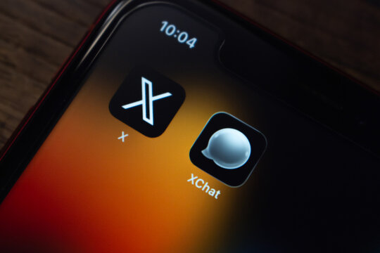 Mexico City, MEXICO - Apr 27 2026 : Close-up of an iPhone home screen displaying the X and XChat app icons side by side.