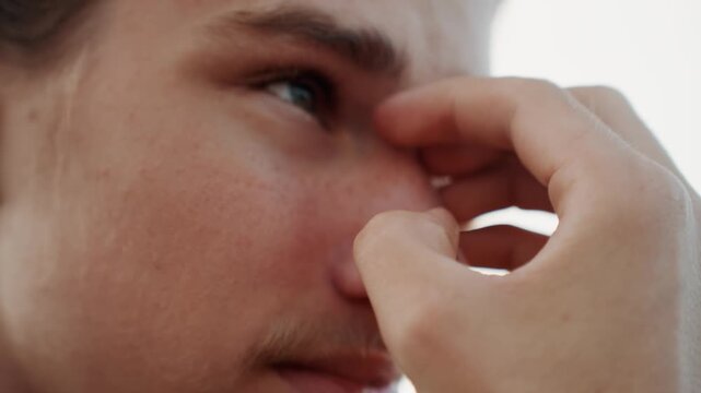 Teen nosebleed treatment. Adolescent receiving calming assistance for nosebleed incident. Young individual showing calm demeanor while receiving first aid for nasal bleeding at home or clinic