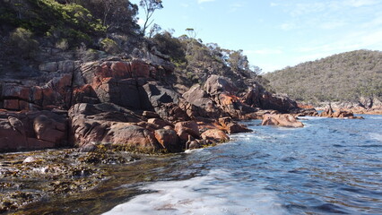 Large boulders and trees on the shore of the sea © HDC Creative