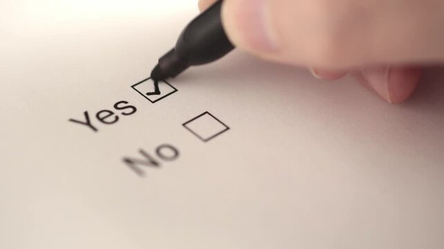 Close-Up Slow Motion of Pen Checking Yes Box on Form