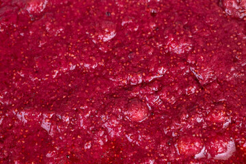 Red berry surface. Closeup of fresh strawberry seeds. Detailed view of strawberries with juicy seeds. Macro photograph showcasing strawberries with vibrant juice and seed detail © beholdereye