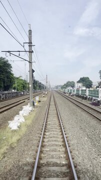 Vertical Perspective of Empty Railway Tracks Stretching to Horizon