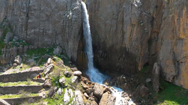 Aerial footage of a waterfall falling from a high cliff in Faraya Lebanon with strong natural scenery