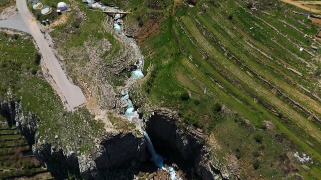 Beautiful drone footage capturing a waterfall in Faraya with rocks, flowing water and natural environment