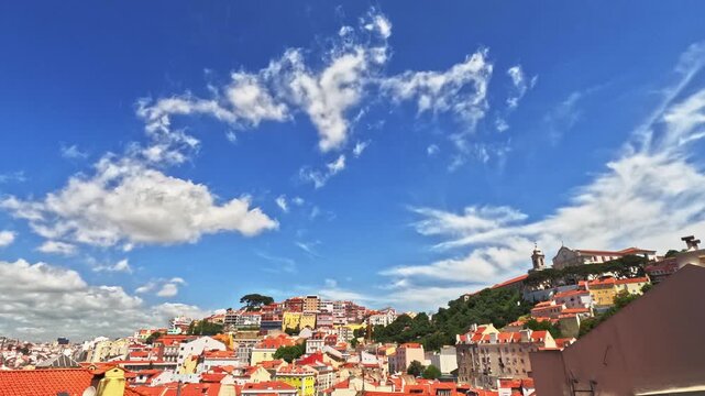 Lisbon old town viewpoint over rooftops. Skyline cityscape time lapse facing Alfama, Graca, Anjos and Martim Moniz neighbourhoods. Historic centre terracotta roofs. Portugal time-lapse, natural render