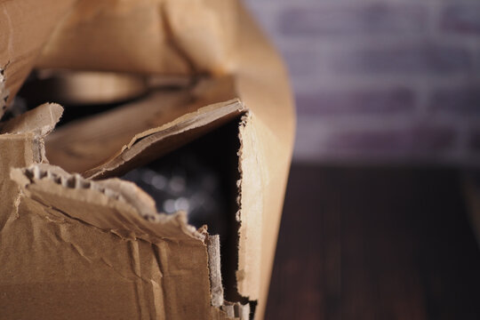 Delivery box shows damage and tearing in corner area